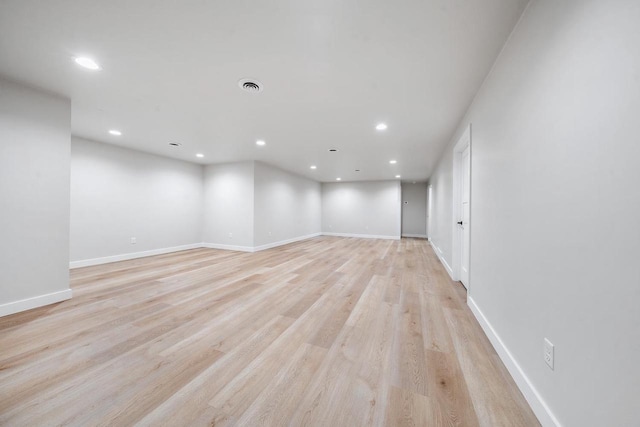 unfurnished room with light wood-style floors, baseboards, visible vents, and recessed lighting