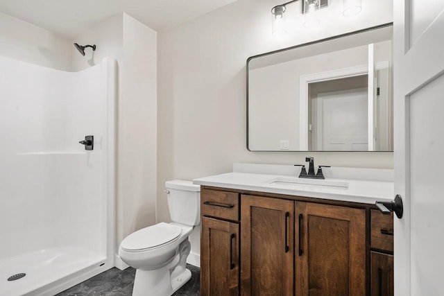 full bathroom featuring toilet, a stall shower, and vanity