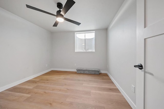 empty room featuring baseboards, ceiling fan, and light wood-style floors