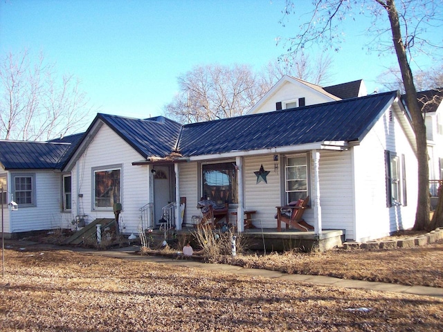 view of front of home featuring a porch and metal roof