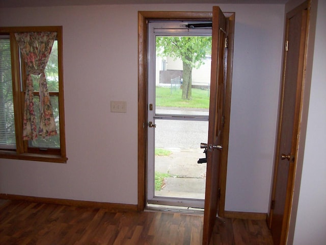 1002 Adams St, Portage, WI 53901 - doorway to outside featuring baseboards and wood finished floors