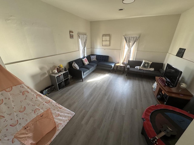 living room with visible vents and wood finished floors