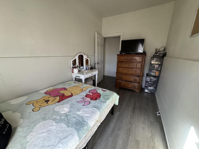 bedroom with dark wood-type flooring