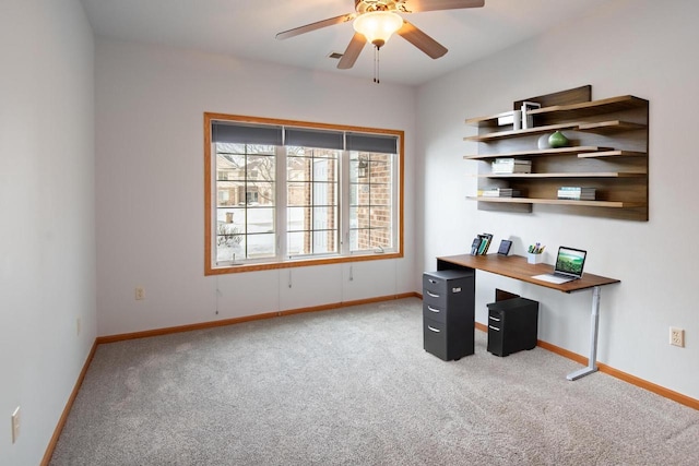 home office featuring ceiling fan, baseboards, and light colored carpet