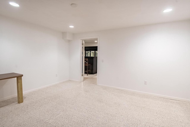 empty room with baseboards, light carpet, and recessed lighting