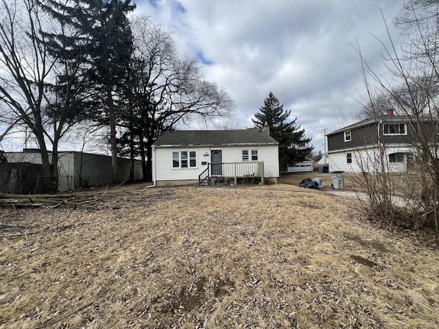 back of house with a wooden deck