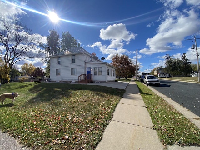 view of side of home featuring a lawn