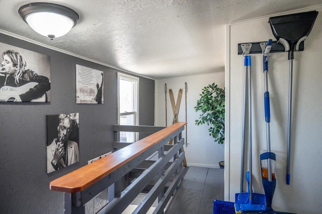 corridor featuring dark wood-type flooring, baseboards, and a textured ceiling