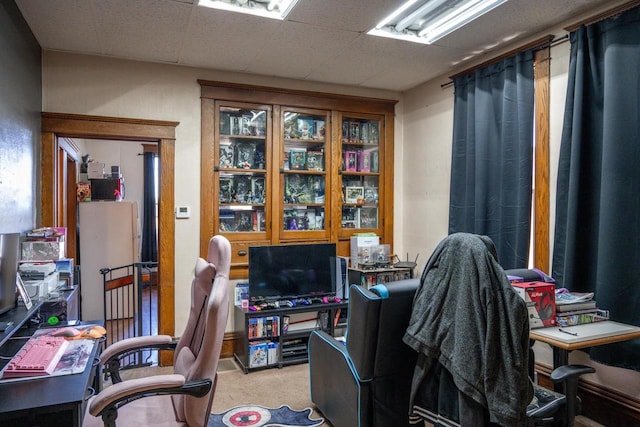 home office featuring carpet floors and a drop ceiling