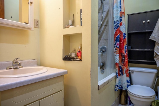 full bath featuring toilet, shower / bath combination with curtain, and vanity