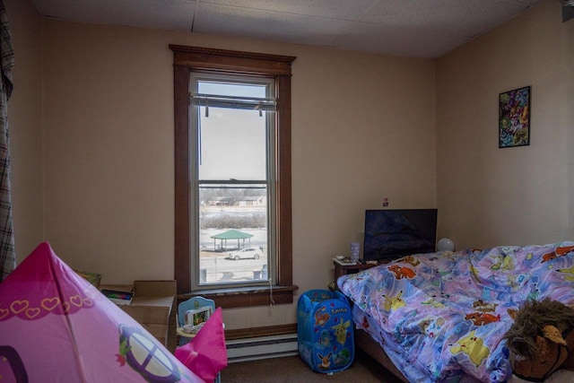 bedroom with a baseboard radiator and carpet flooring