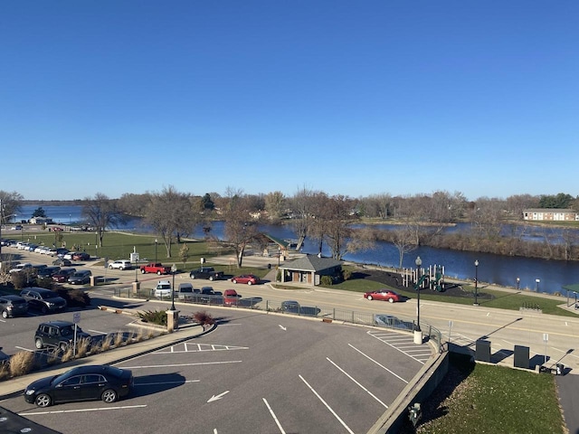 uncovered parking lot with a water view