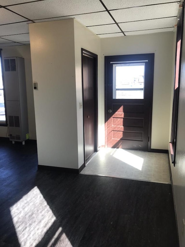 entryway with a paneled ceiling and wood finished floors