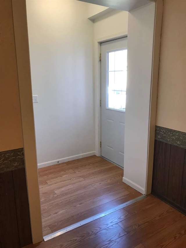 entryway with baseboards and wood finished floors