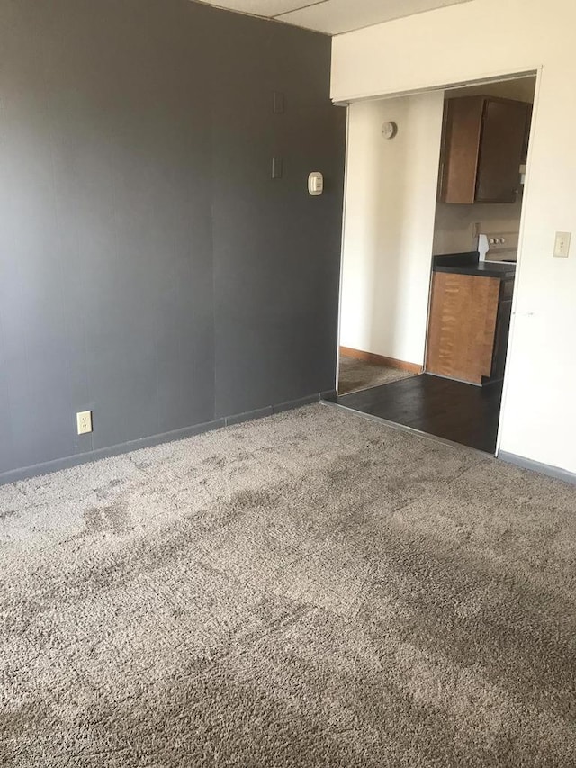 spare room with carpet and baseboards