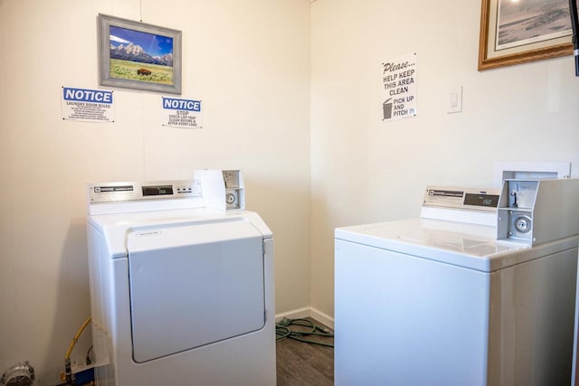 common laundry area featuring washer and clothes dryer, wood finished floors, and baseboards