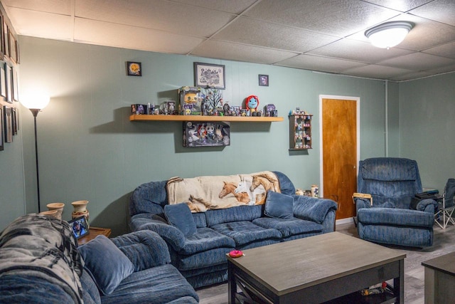 living room featuring a drop ceiling and wood finished floors