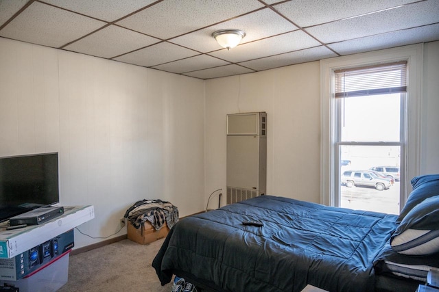 carpeted bedroom with a drop ceiling