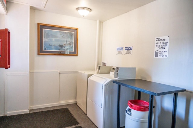 common laundry area featuring washing machine and dryer and wainscoting