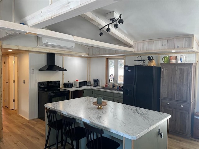 155 Zach St, Glidden, WI 54527 - kitchen featuring vaulted ceiling with beams, a sink, light wood-style floors, wall chimney exhaust hood, and black appliances