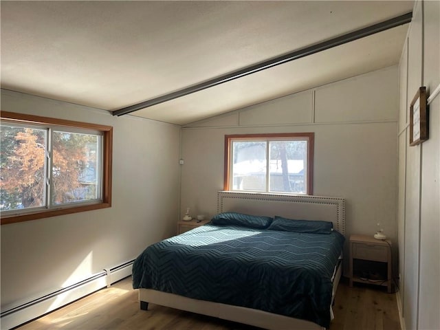 155 Zach St, Glidden, WI 54527 - bedroom with lofted ceiling, multiple windows, baseboard heating, and wood finished floors