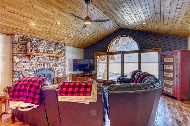 living area featuring vaulted ceiling, hardwood / wood-style floors, a fireplace, and wood ceiling