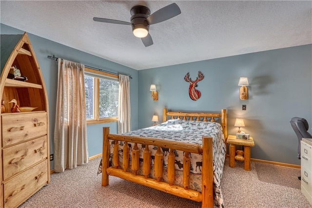 bedroom with a ceiling fan, light colored carpet, a textured ceiling, and baseboards