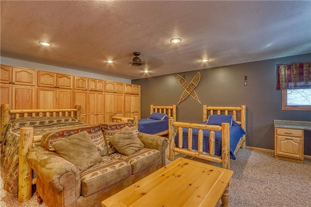 carpeted bedroom with recessed lighting, a textured ceiling, and baseboards