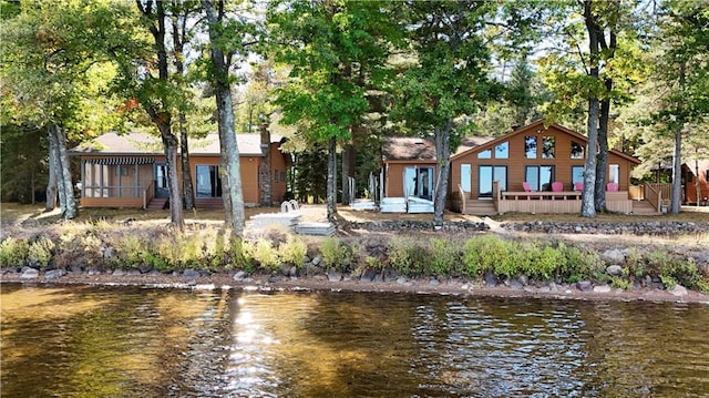 rear view of property with a deck with water view