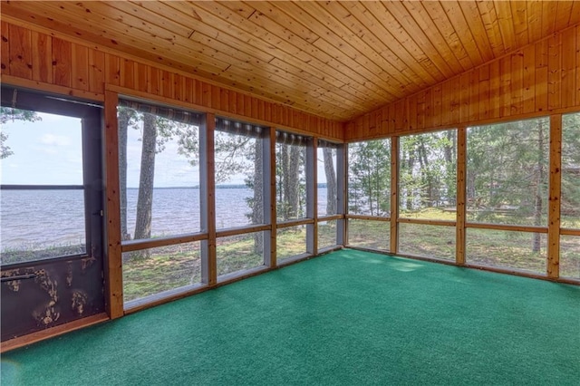 unfurnished sunroom with wood ceiling, a water view, and vaulted ceiling