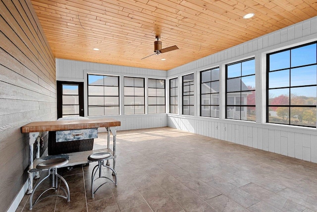 sunroom / solarium with wooden ceiling and ceiling fan