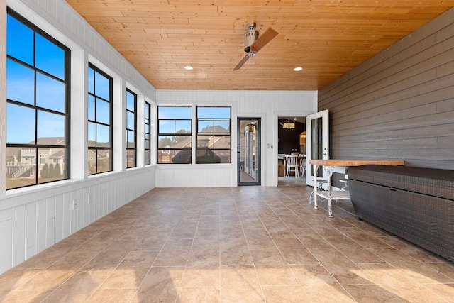 unfurnished sunroom featuring wooden ceiling and plenty of natural light
