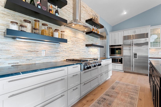 kitchen with stainless steel appliances, white cabinets, backsplash, open shelves, and dark countertops