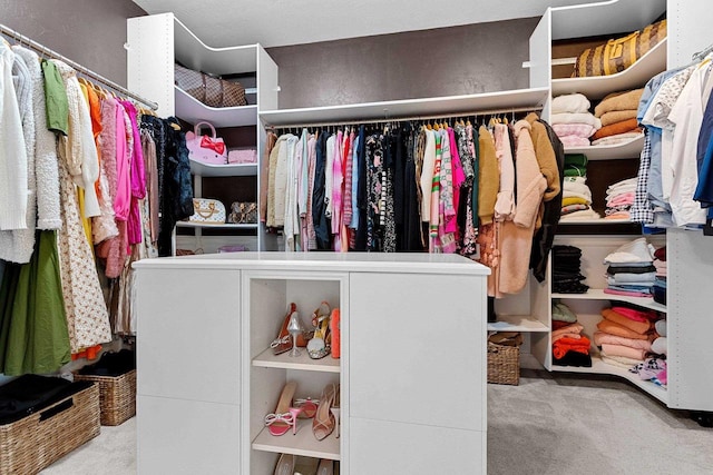 walk in closet with carpet floors
