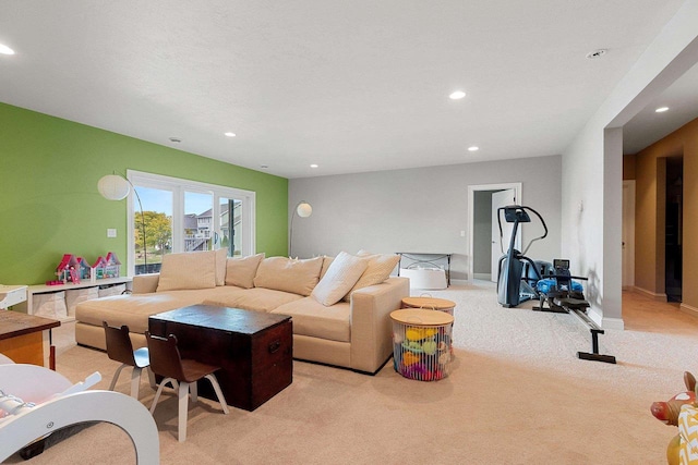 living area with light carpet and recessed lighting