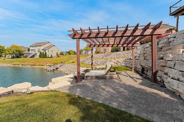 view of patio with a water view and a pergola