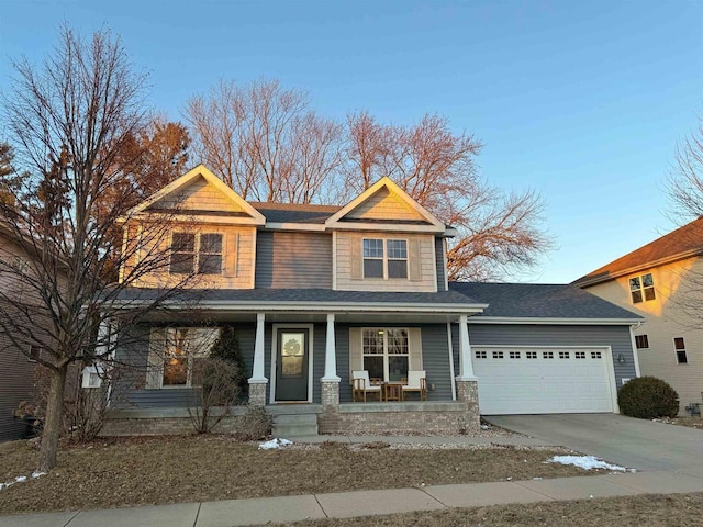 craftsman-style house with covered porch, concrete driveway, and an attached garage