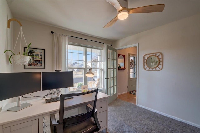 office space featuring a ceiling fan, baseboards, and carpet floors