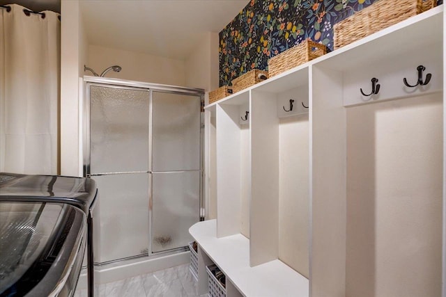 mudroom featuring marble finish floor and washer and dryer