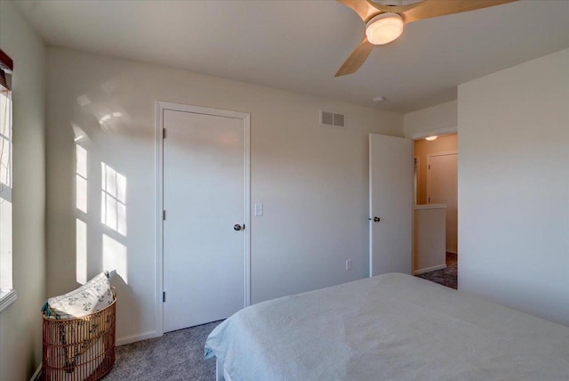 carpeted bedroom with visible vents and ceiling fan