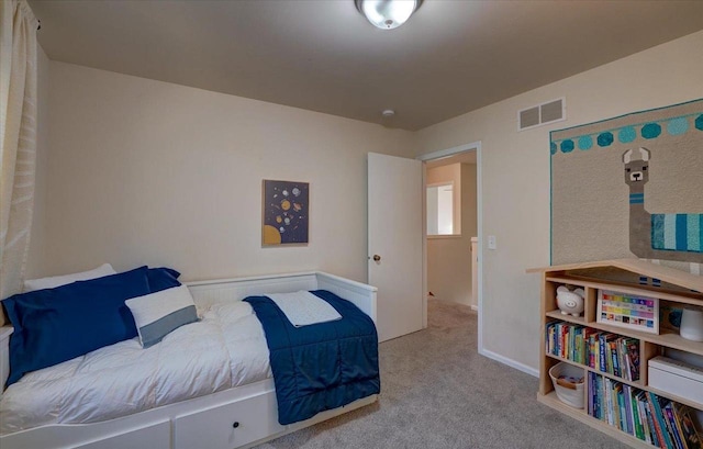 carpeted bedroom featuring visible vents