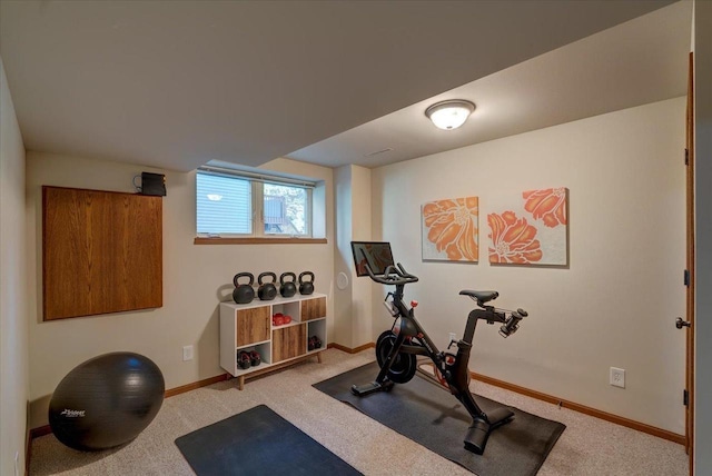 workout room featuring carpet flooring and baseboards