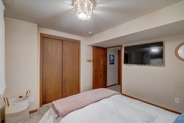 bedroom featuring a closet, carpet flooring, and baseboards