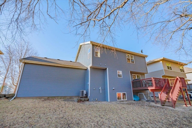 rear view of property featuring stairs, central AC, and a wooden deck