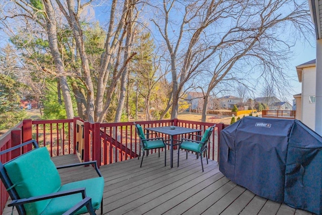 wooden deck featuring grilling area and outdoor dining space