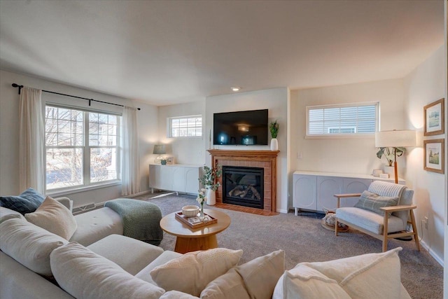 carpeted living area featuring baseboards and a fireplace