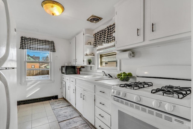 kitchen featuring a sink, visible vents, a healthy amount of sunlight, open shelves, and white gas range