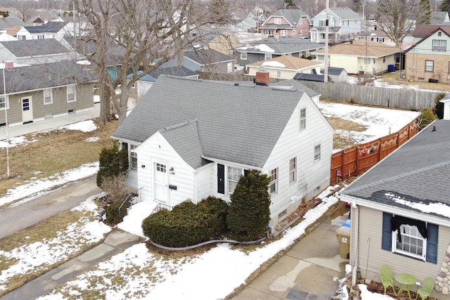 snowy aerial view with a residential view