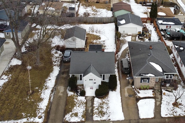 snowy aerial view with a residential view