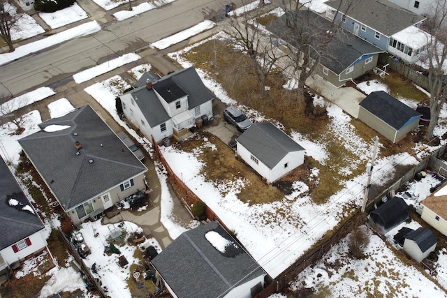 snowy aerial view with a residential view